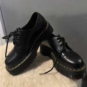 Dr. Martens Black Flats with Glossy Leather and Signature Stitching