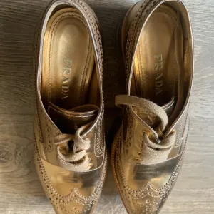 Prada Gold Brogue Oxford Shoes